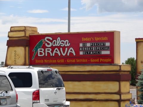 1992 Ford Taurus - A sign for Salsa Brava restaurant advertises today's specials, including a 10 percent Monday special for the Olympics.