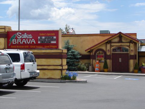 1992 Ford Taurus - Two SUVs are parked in front of a restaurant with a 'Salsa Brava' sign.