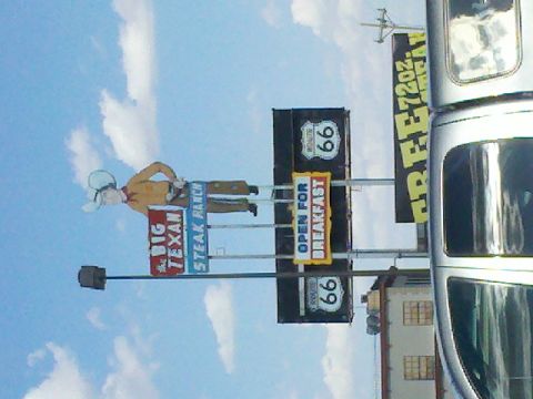 1992 Ford Taurus - A roadside scene prominent signage for The Big Texan Steak Ranch and Route 66, indicating it is open for breakfast.