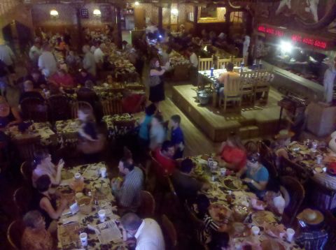 1992 Ford Taurus - Diners are seated at tables in a dimly lit restaurant with a stage area.