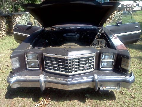 1979 Ford Ranchero - The front of a 1979 Ford Ranchero is shown with its hood and doors open, revealing the engine compartment.