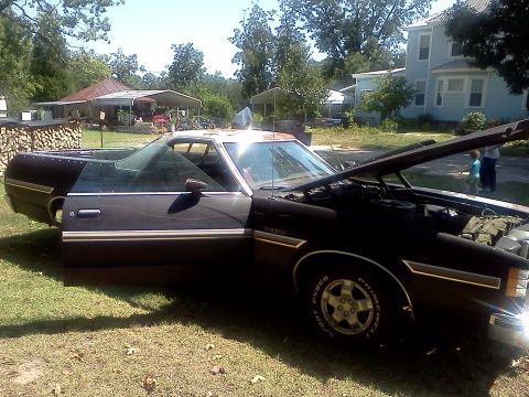 1979 Ford Ranchero - The vehicle has its hood and driver's door open, revealing the engine bay and interior.