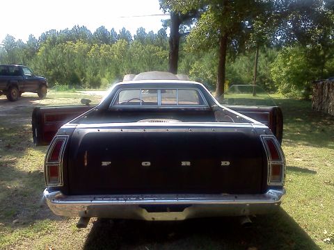 1979 Ford Ranchero - This 1979 Ford Ranchero is seen from the rear with its doors open, parked outdoors next to another truck.