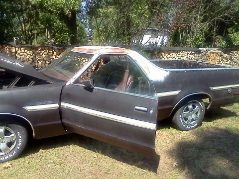 1979 Ford Ranchero - This 1979 Ford Ranchero is parked outdoors with its hood and driver's door open, revealing the interior and engine bay.