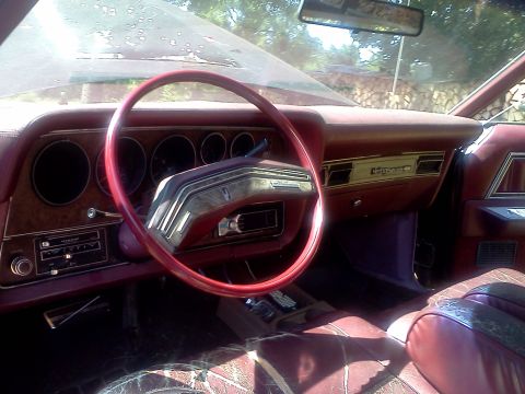 1979 Ford Ranchero - Interior view of a 1977 Ford Thunderbird, with wood grain accents and red upholstery visible.
