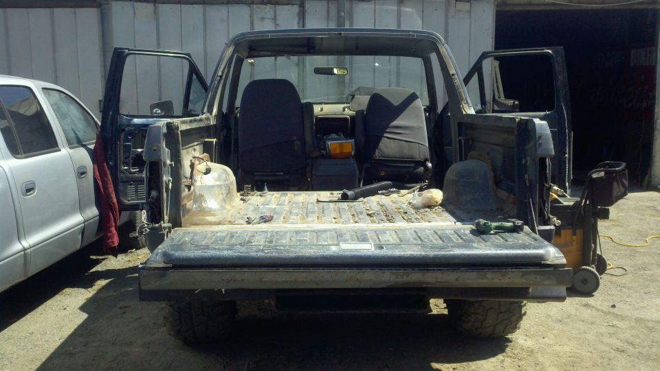 Rear view of a 1989 Ford Bronco with doors open and interior exposed