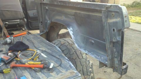 1989 Ford Bronco - Tools and parts are laid out in the interior of a Ford Bronco, suggesting repair work is underway.