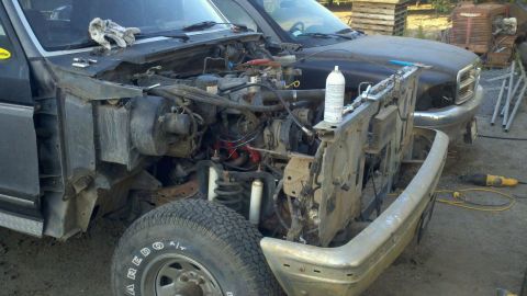 1989 Ford Bronco - Front end of a 1989 Ford Bronco disassembled for repair, showing the engine bay.