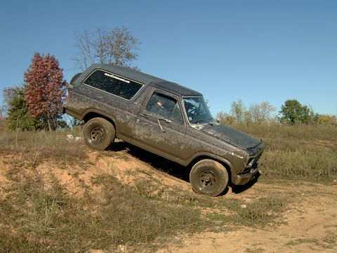 1982 Ford Bronco - This 1980s Ford Bronco is shown navigating a challenging off-road terrain.