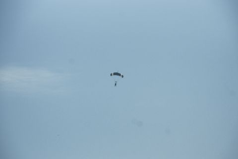 1995 Ford Taurus - A skydiver is falling through the sky with an open parachute.