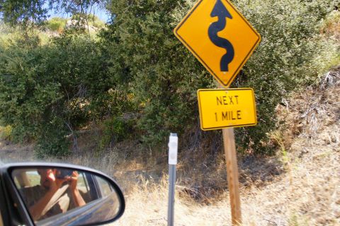 1995 Ford Taurus - Road sign indicates upcoming winding road for the next mile.