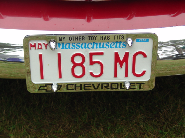 Massachusetts plate 1185 MC in chrome Chevrolet frame on red car's chrome bumper