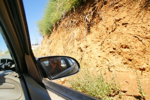1995 Ford Taurus - Driving on a dirt road with a steep embankment visible from the passenger side window.