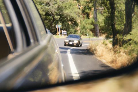 1995 Ford Taurus - A car travels down a rural road, seen from the perspective of another vehicle.