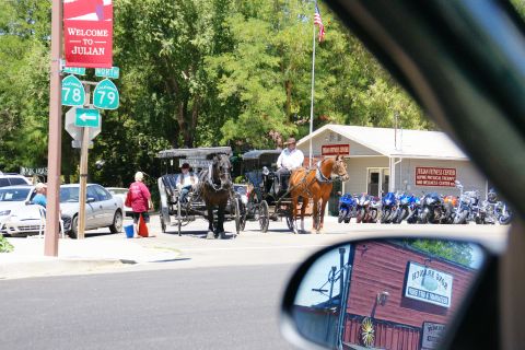 1995 Ford Taurus - A street scene in Julian, California, shows horse-drawn carriages and a row of motorcycles parked outside a business.