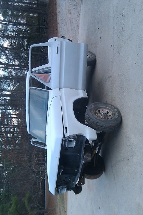 1978 Ford Bronco - This 1978 Ford Bronco is in primer gray with its doors open and front end disassembled.