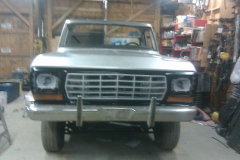 1978 Ford Bronco - Front view of a 1978 Ford Bronco undergoing restoration in a workshop.