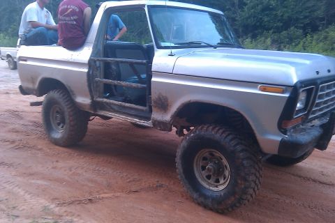 1978 Ford Bronco - This modified pickup truck features a roll cage on the doors and is equipped for off-road use.