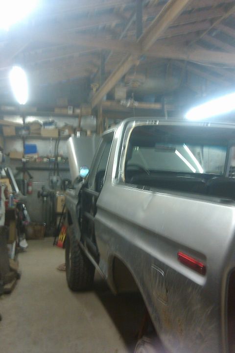 1978 Ford Bronco - This 1978 Ford Bronco is seen in a garage with its hood up, suggesting it is undergoing maintenance or restoration.