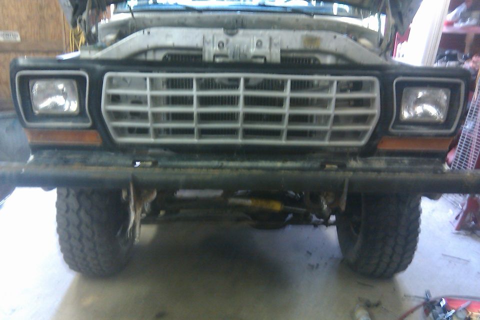 Front view of a 1979 Ford F-Series truck with hood open. It has a white grille and square headlights