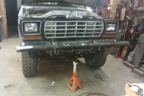 1978 Ford Bronco - The front of a 1978 Ford Bronco is visible, showing its grille and bumper.