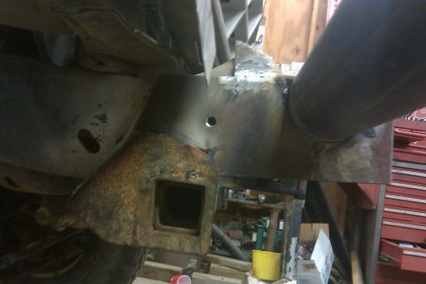 1978 Ford Bronco - Close-up view of a modified vehicle frame, showing a square receiver hitch and welded metalwork.
