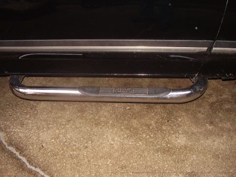 1988 Ford Bronco - Close-up of a black SUV's side step, the 'Westin' brand name.