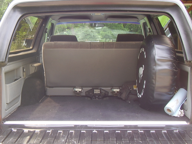 Interior cargo area of a 1988 Ford Bronco with spare tire cover reading 'Ford Bronco'