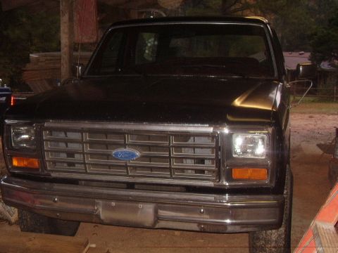 1986 Ford Bronco - Front view of a black Ford truck, likely from the early 1980s.