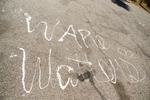 1995 Ford Taurus - Chalk writing on a paved surface reads "Ware Watcn".