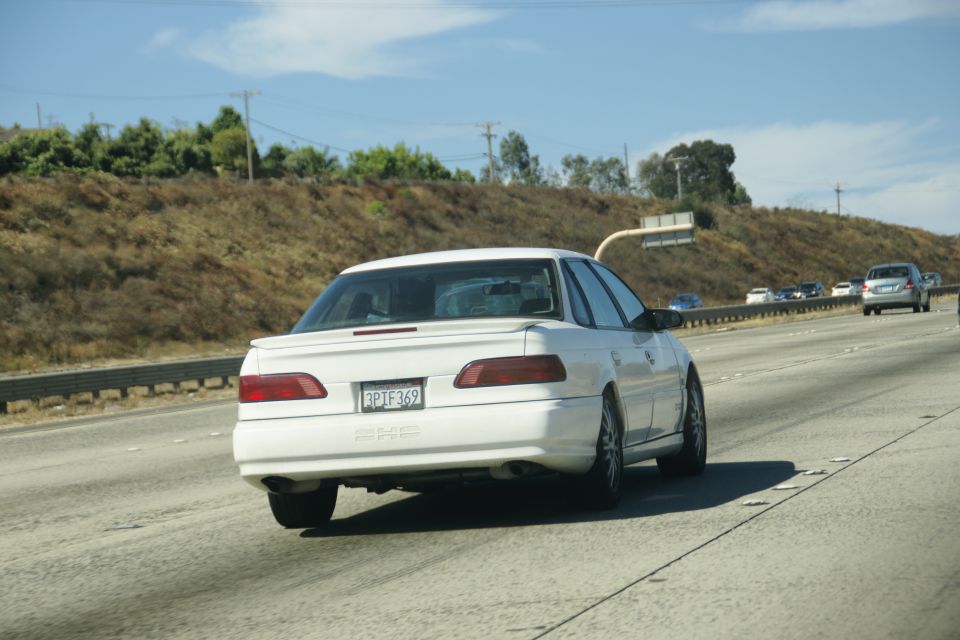 White 1995 Ford Taurus sedan from rear, on highway, license plate 3P1F369