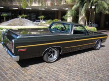 1979 Ford Ranchero - This pickup truck has a distinctive yellow stripe running along its side and chrome accents.