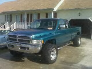 1997 Dodge 2500 - Teal 1997 Dodge 2500 pickup truck shown from the front 3/4 angle. A "SUPERMOTORS" watermark is visible in the lower right corner.