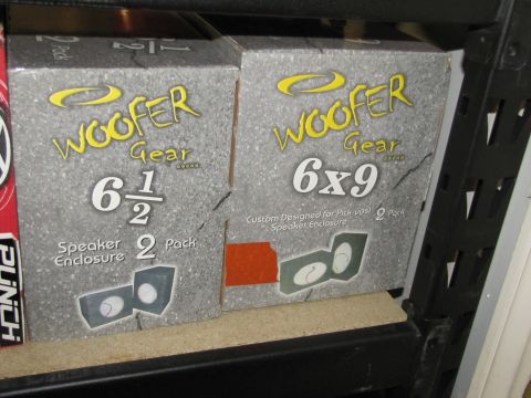 1995 Ford Bronco - Boxes of Woofer Gear speaker enclosures for 6 1/2 inch and 6x9 inch speakers are displayed on a shelf.
