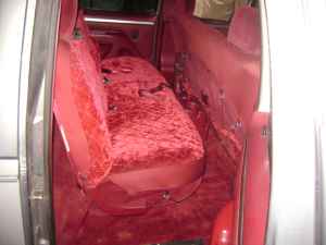 1995 Ford Bronco - Interior view of a van with red velour seats and carpeting.
