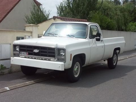 1991 Ford LTD Crown Victoria - This white Chevrolet C/K pickup truck appears to be from the 1973 to 1974 model year range.