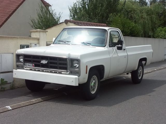 White Chevrolet C/K pickup truck from the 1970s parked on a street