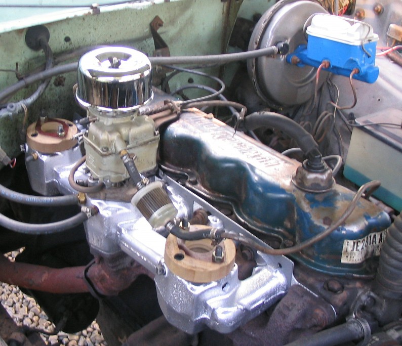 Inline six engine with polished aluminum intake, chrome air cleaner and blue valve cover
