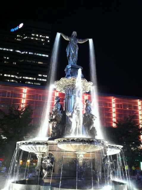 1987 Suzuki Samurai - A grand fountain is illuminated at night, with water flowing from statues and multiple tiers.