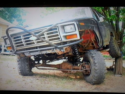 1986 Ford Bronco - This heavily modified truck features a custom front bumper and a lifted suspension, giving it an aggressive off-road stance.
