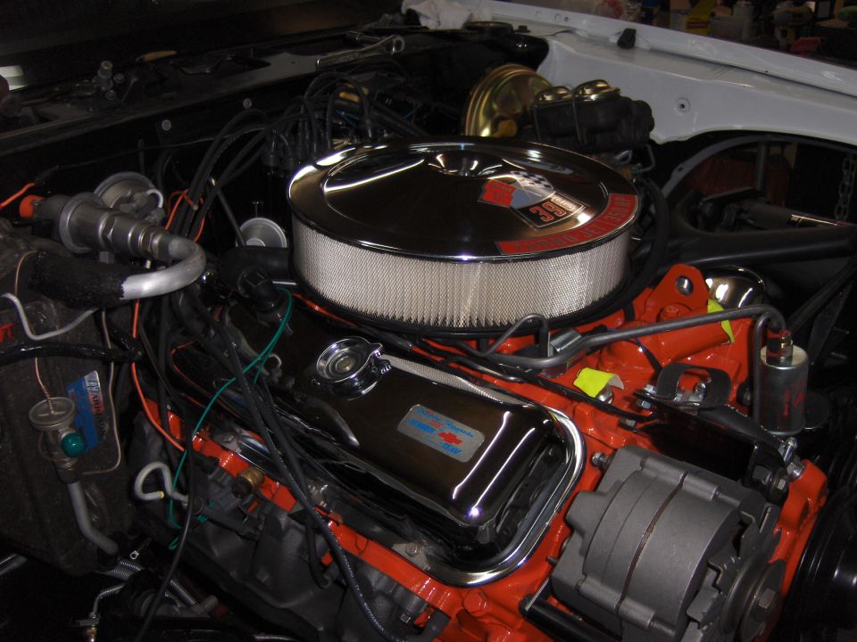 Engine bay with chrome air cleaner and valve covers, showing a 350 badge