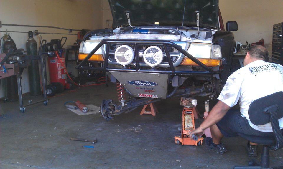 1992 Ford Ranger front end lifted on jacks with front bumper removed and engine exposed