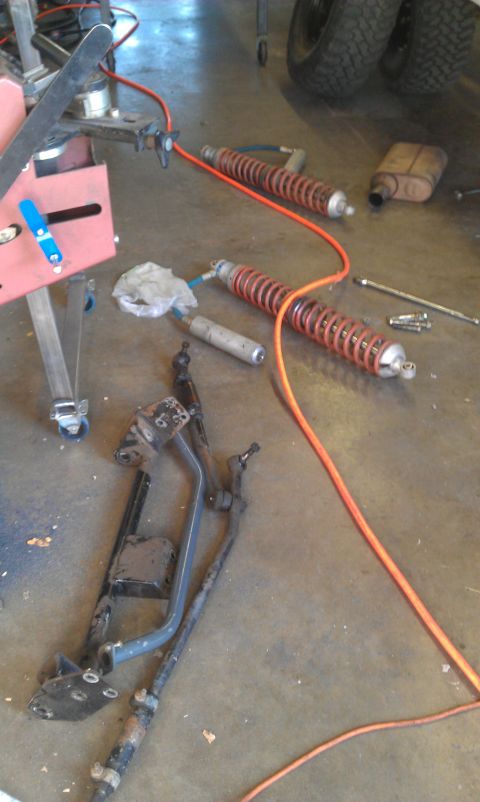 1992 Ford Ranger - Various automotive suspension components are visible on the concrete floor, suggesting a repair or upgrade in progress.
