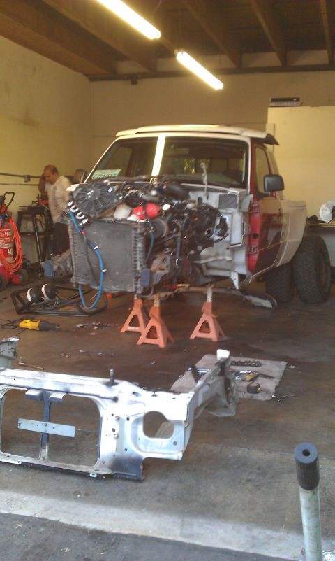 1992 Ford Ranger - A truck is in a garage being worked on, with its engine removed and chassis disassembled.
