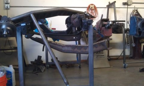 1992 Ford Ranger - The vehicle's frame is disassembled and mounted on stands for modification in a workshop setting.