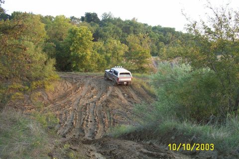 1982 Ford Bronco - This 1980s Ford Bronco navigates a challenging muddy terrain, its off-road capabilities.