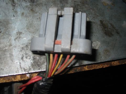 1992 Ford Bronco - Close-up of a gray electrical connector with several wires leading from it.