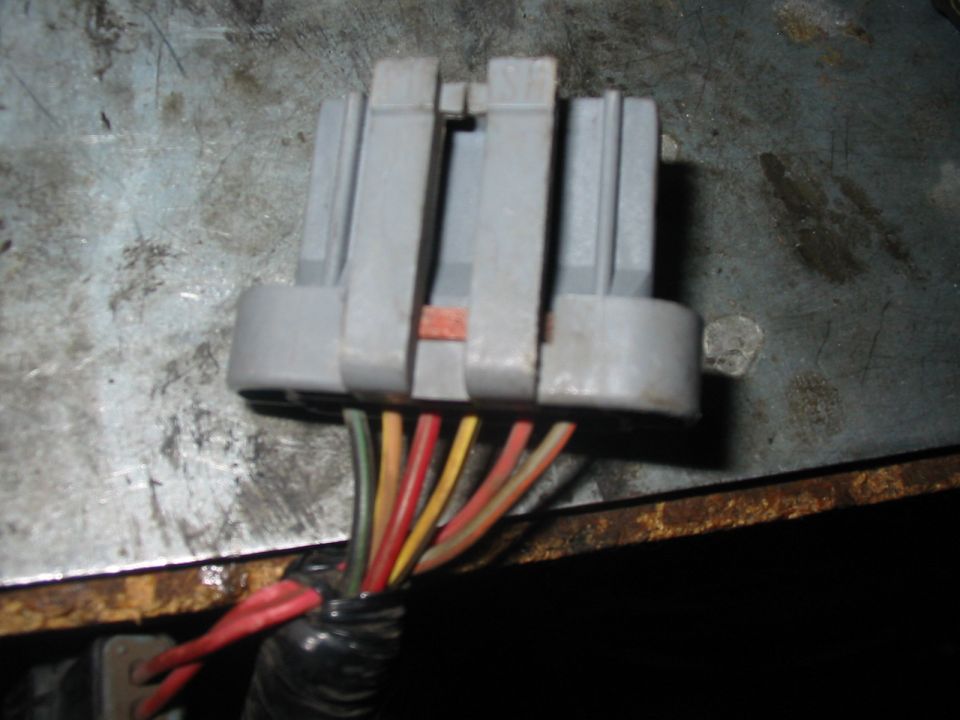 Gray electrical connector with multiple colored wires (red, yellow, green, orange)