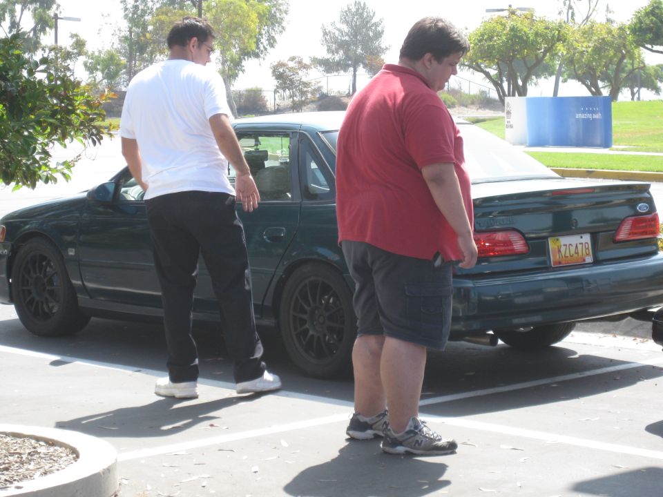 Dark green sedan with a yellow license plate reading XZC478, viewed from the rear