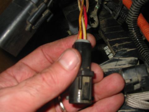 1992 Ford Bronco - A close-up view of a vehicle's wiring harness connector with multiple colored wires.